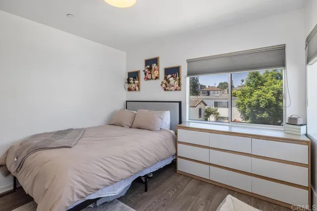a bedroom with a bed and a large window