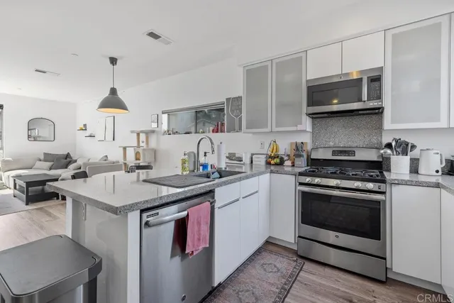a kitchen with stainless steel appliances granite countertop a stove and a sink