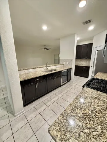 a kitchen with stainless steel appliances a sink and a refrigerator