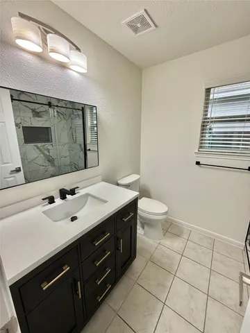 a bathroom with a glass door shower and a sink