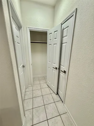 a room with a white bed and a shower