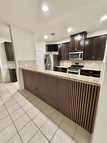a kitchen with stainless steel appliances a sink and a refrigerator