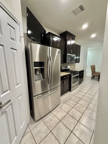 a kitchen with stainless steel appliances a refrigerator and a sink