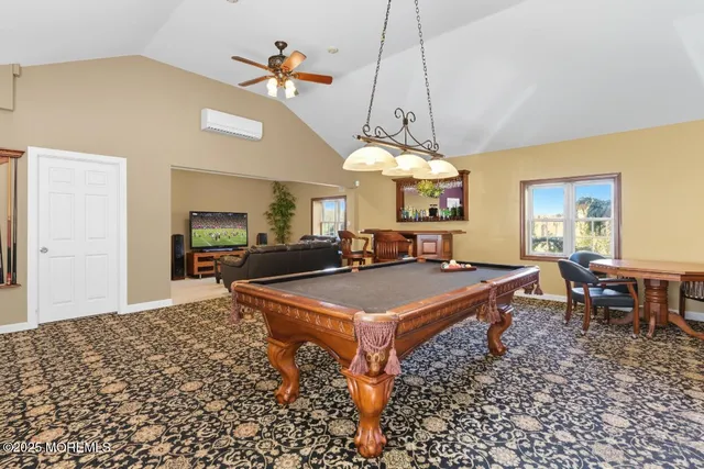 a room with pool table and windows