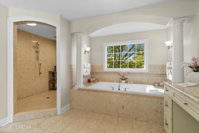 a bathroom with a tub sink and a shower