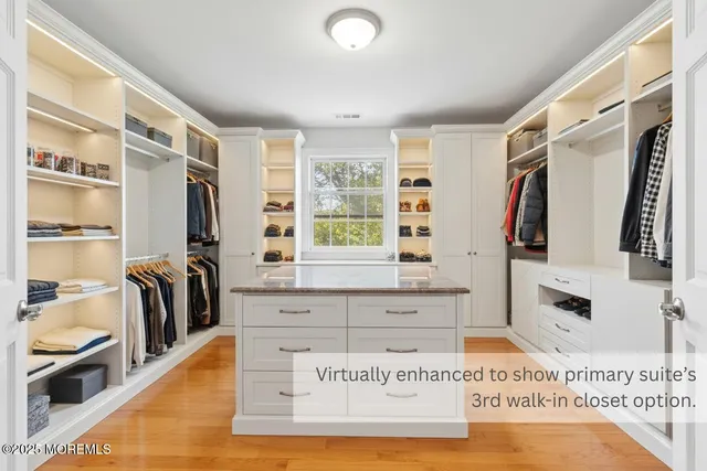 a view of walk in closet with clothes and shoes