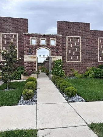 a front view of a house with a garden and plants