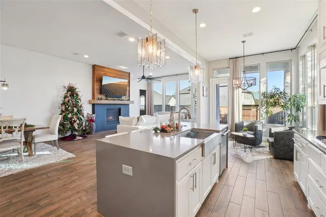a kitchen with sink stove and wooden floor