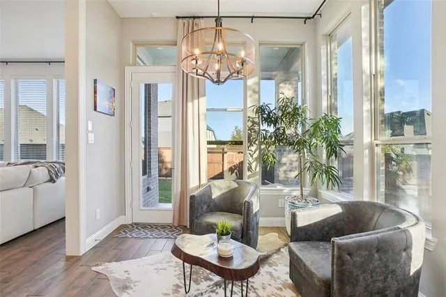 a living room with furniture a chandelier and a large mirror