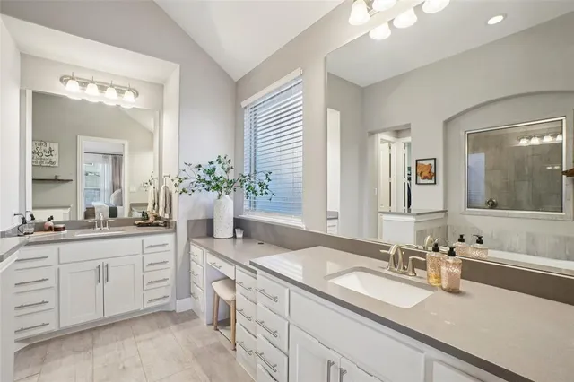 a bathroom with a tub sink and mirror