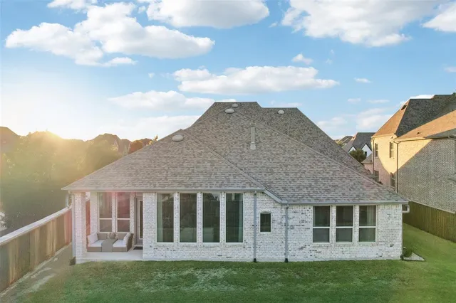 an aerial view of a house with a yard