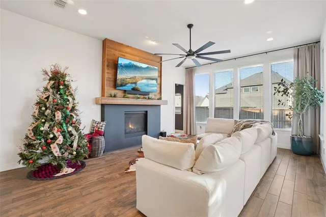 a living room with furniture a chandelier and a fireplace