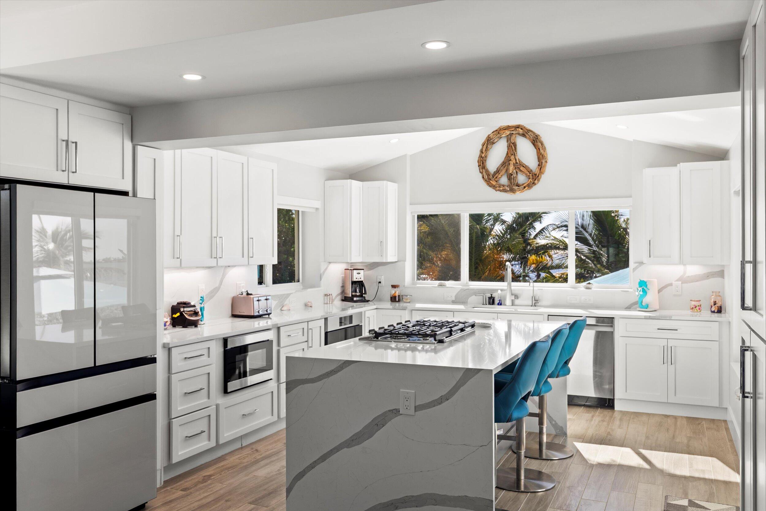 680 Elma Avenue Big Pine Key, FL 33043 - Photo 11 of 89 a kitchen with a stove oven cabinets a dining table and chairs