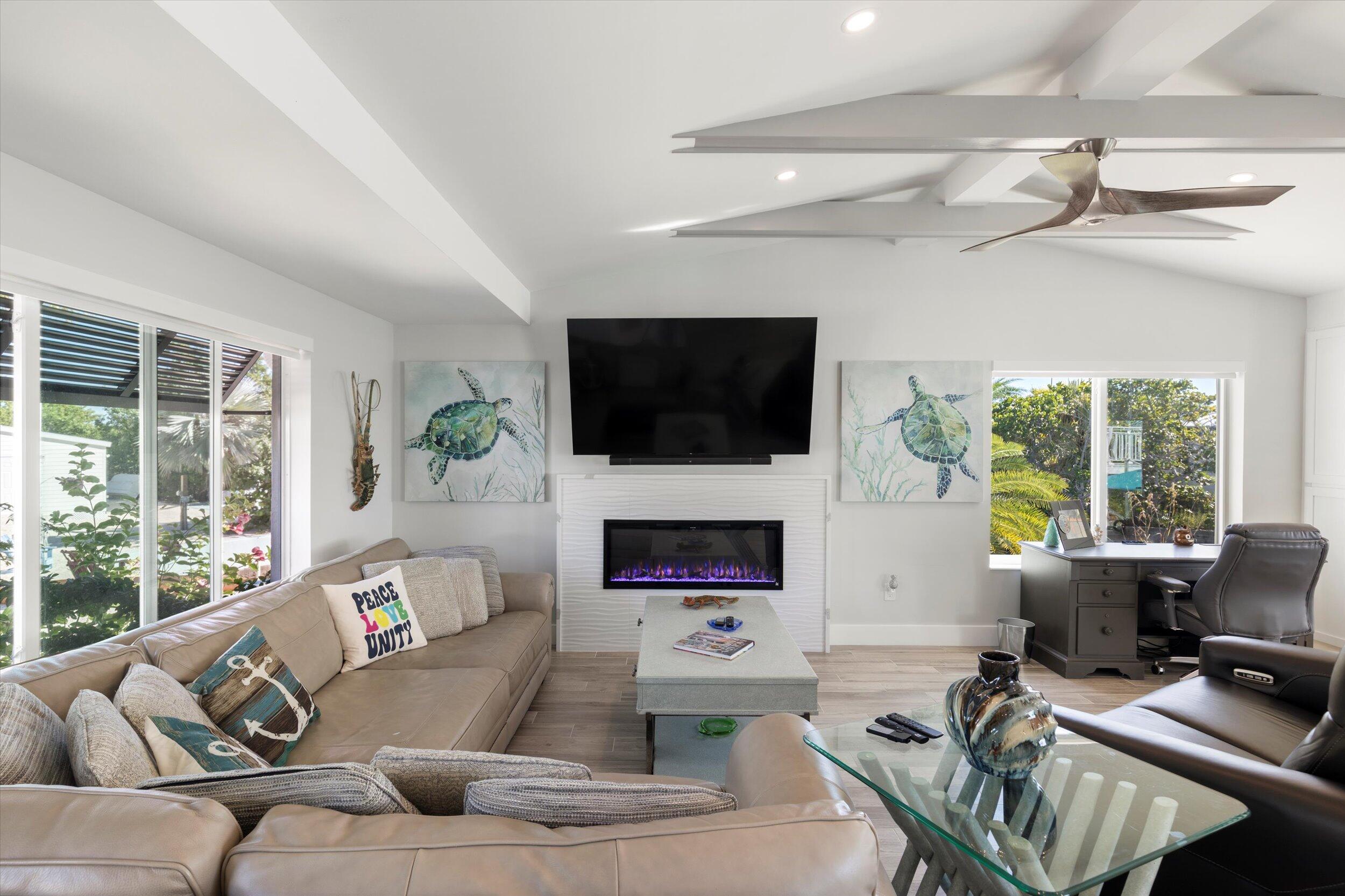 680 Elma Avenue Big Pine Key, FL 33043 - Photo 18 of 89 a living room with furniture a fireplace and a flat screen tv
