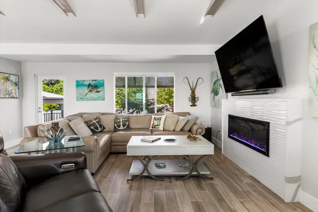 an aerial view of a house with swimming pool and deck