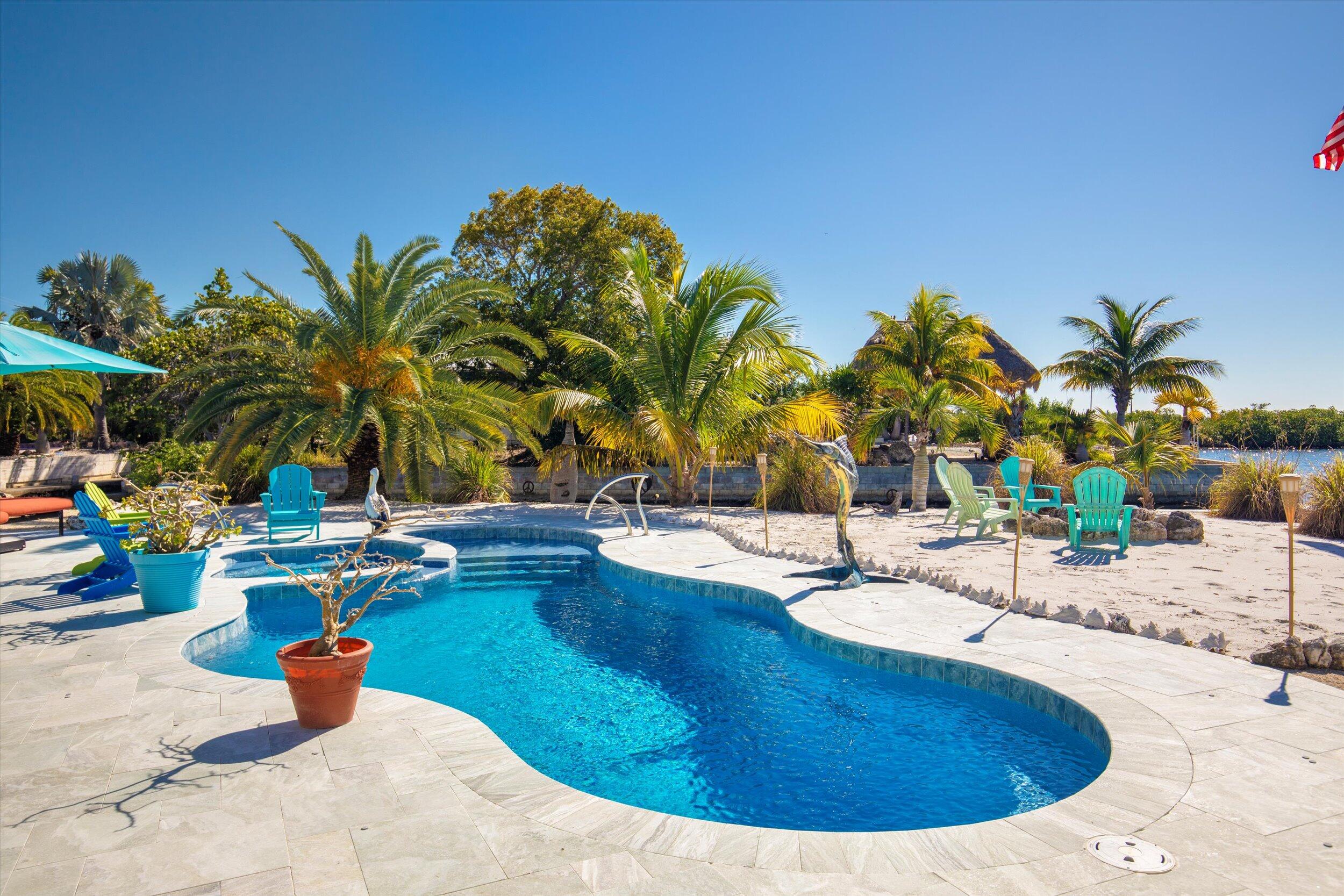 680 Elma Avenue Big Pine Key, FL 33043 - Photo 53 of 89 a view of a swimming pool with lounge chairs