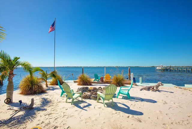 a bed sitting in a bedroom next to a large window with balcony view
