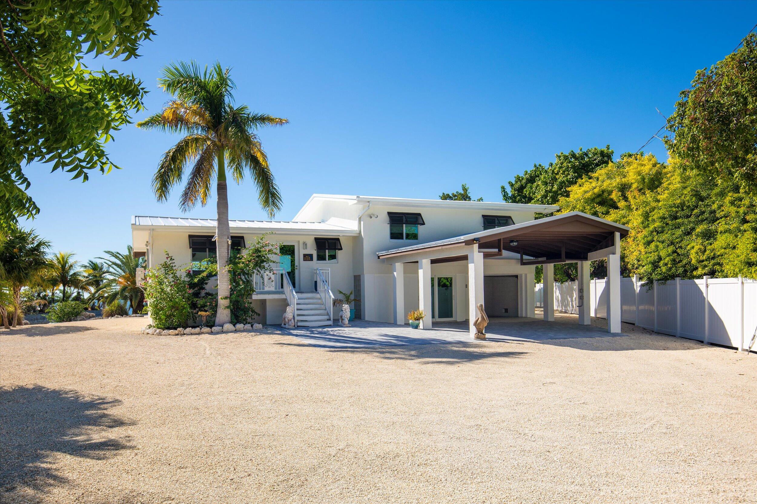 680 Elma Avenue Big Pine Key, FL 33043 - Photo 10 of 89 a front view of a house with a garden