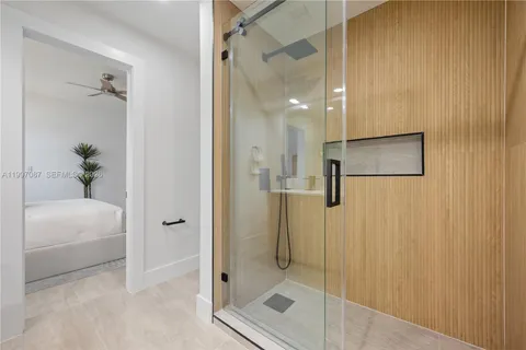 a bathroom with a shower and a sink