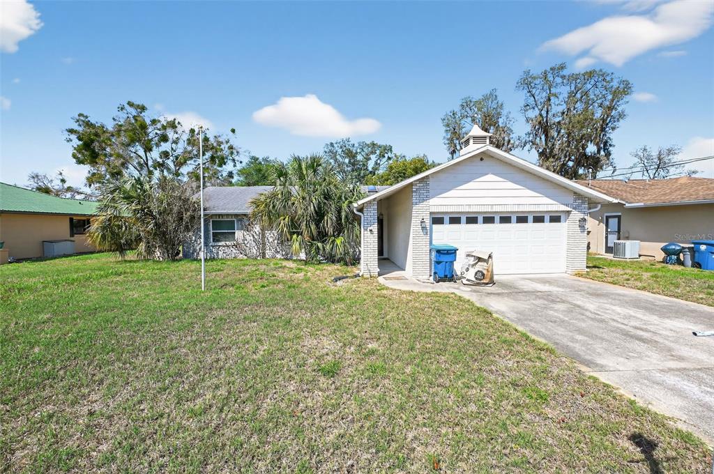 5257 Abagail Drive Spring Hill, FL 34608 - Photo 1 of 1 a front view of a house with a yard and garage