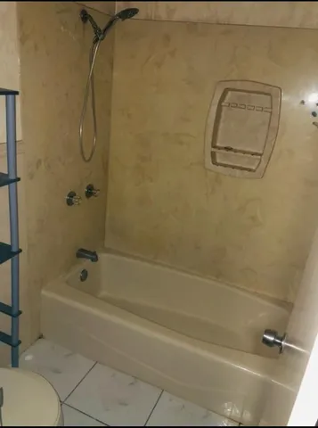 a bathroom with a granite countertop sink and mirror