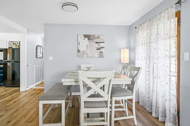a view of a dining room with furniture and wooden floor