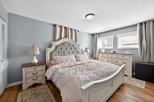 a bed sitting in a bedroom next to a window