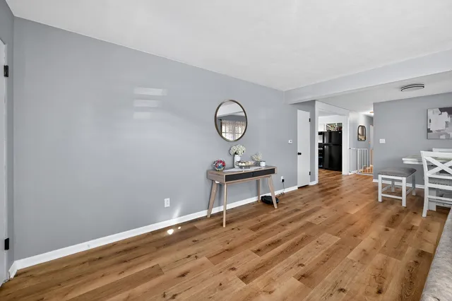 a living room with furniture a table and wooden floor