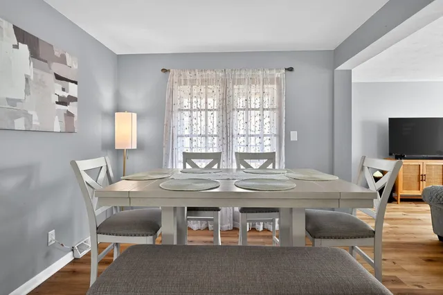 a dining room with furniture and wooden floor