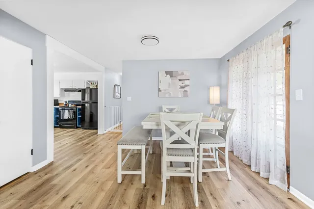 a dining room with furniture and wooden floor