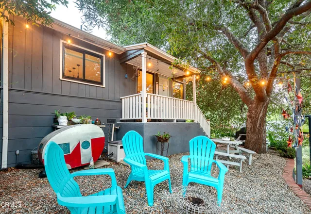 a front view of house with outdoor seating