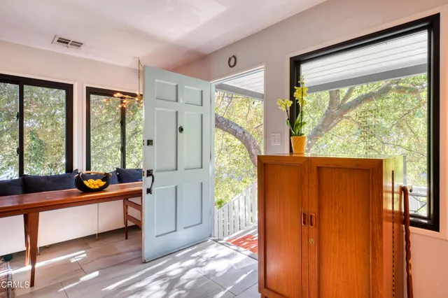 a room with large window and furniture