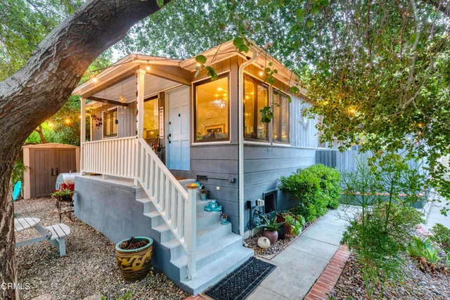 a view of a house with backyard and sitting area
