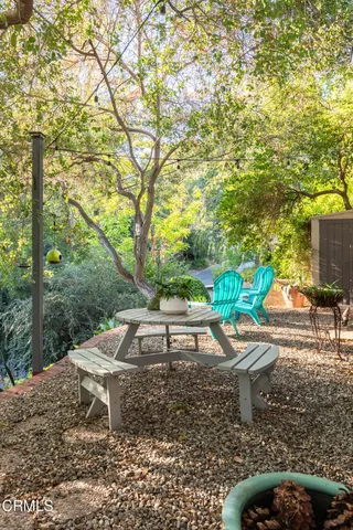 a wooden bench sitting in the backyard