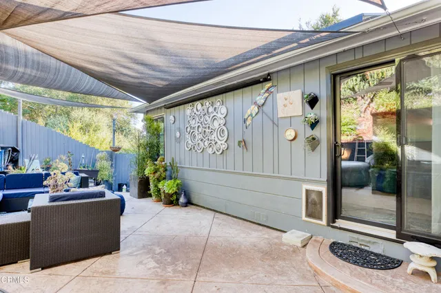 a building outdoor space with patio furniture and potted plants