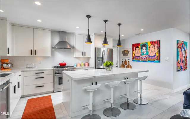 a kitchen with stainless steel appliances kitchen island granite countertop a sink and cabinets
