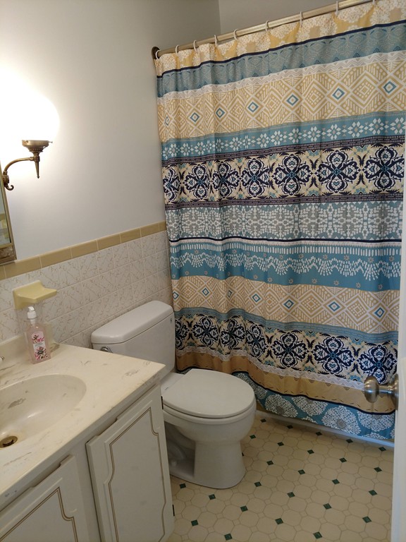 683 Old Post Road, Unit 18 Dennis, MA 02638 - Photo 12 of 25 a bathroom with a sink a toilet and a mirror