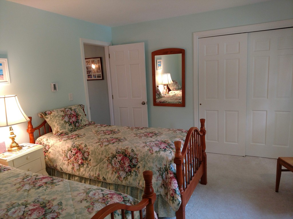 683 Old Post Road, Unit 18 Dennis, MA 02638 - Photo 13 of 25 a bedroom with a bed and a mirror