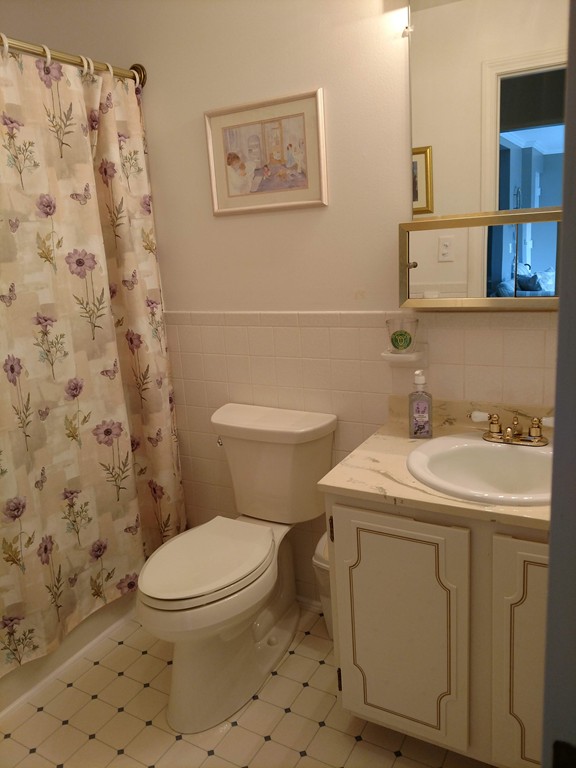 683 Old Post Road, Unit 18 Dennis, MA 02638 - Photo 14 of 25 a bathroom with a sink toilet and a mirror