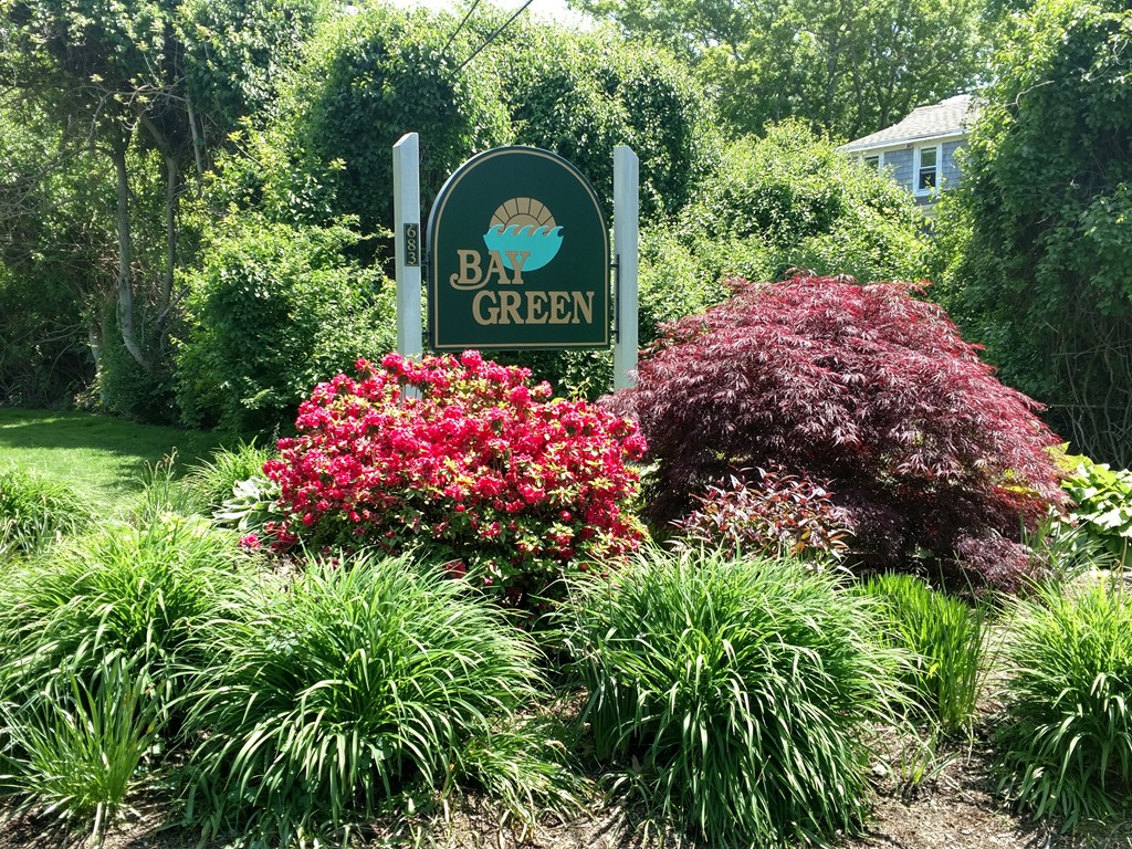 683 Old Post Road, Unit 18 Dennis, MA 02638 - Photo 25 of 25 a sign that is sitting in front of flowers