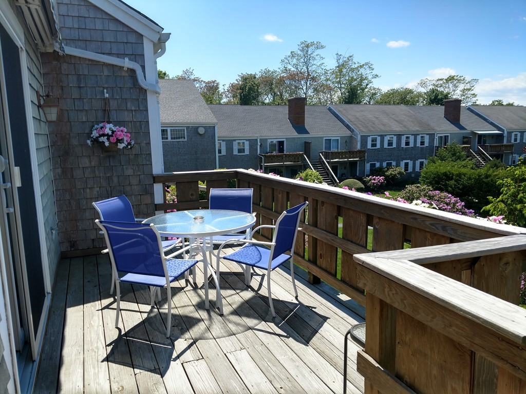 683 Old Post Road, Unit 18 Dennis, MA 02638 - Photo 3 of 25 a view of a chairs and table in the balcony