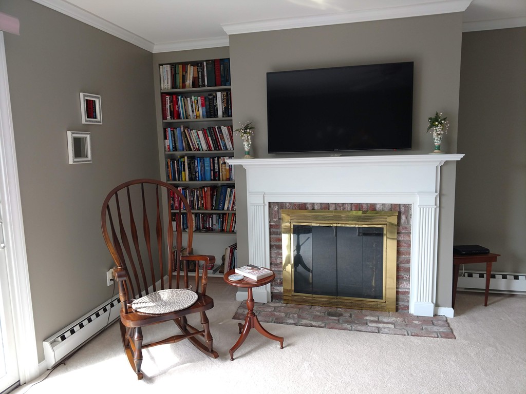 683 Old Post Road, Unit 18 Dennis, MA 02638 - Photo 4 of 25 a living room with fireplace furniture and a flat screen tv