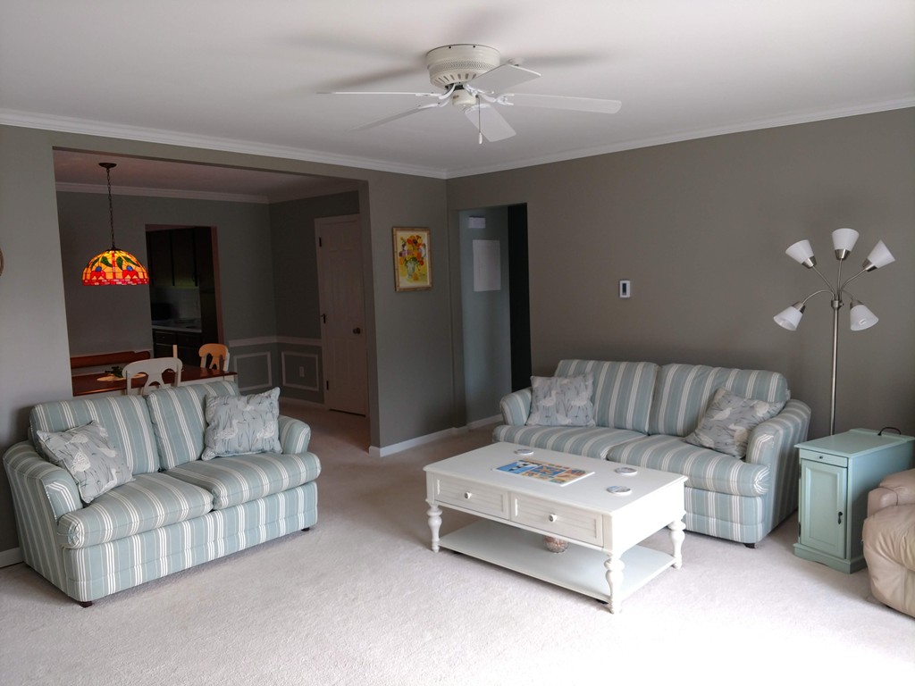 683 Old Post Road, Unit 18 Dennis, MA 02638 - Photo 5 of 25 a living room with furniture and a ceiling fan