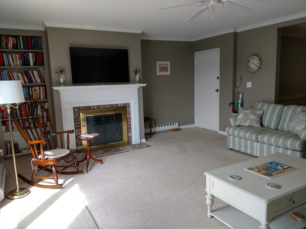 683 Old Post Road, Unit 18 Dennis, MA 02638 - Photo 6 of 25 a living room with furniture and a fireplace