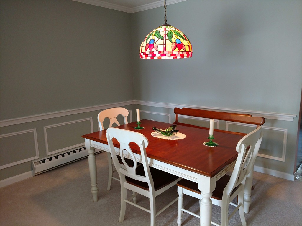 683 Old Post Road, Unit 18 Dennis, MA 02638 - Photo 7 of 25 a view of a dining room with furniture and a chandelier