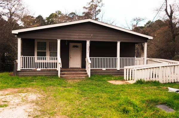 a front view of a house with a garden