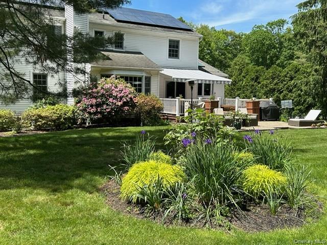 16 Fox Den Road Mount Kisco, NY 10549 - Photo 7 of 44 Electric remote controlled awning covering deck with adjacent patio provides shade in the sunlit back yard