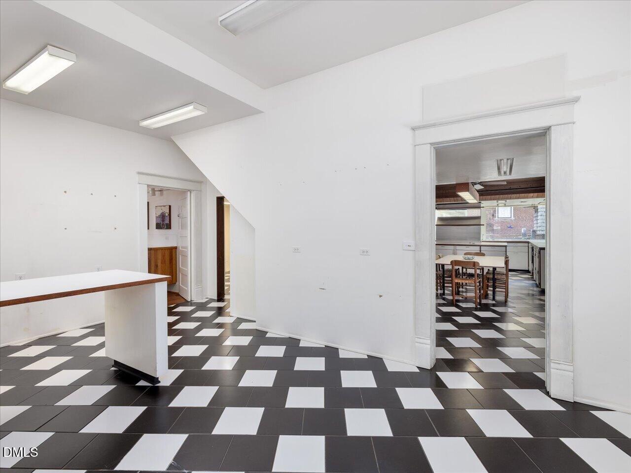 215 Hillcrest Road Raleigh, NC 27605 - Photo 39 of 97 a view of a hallway with a black and white checkered floor