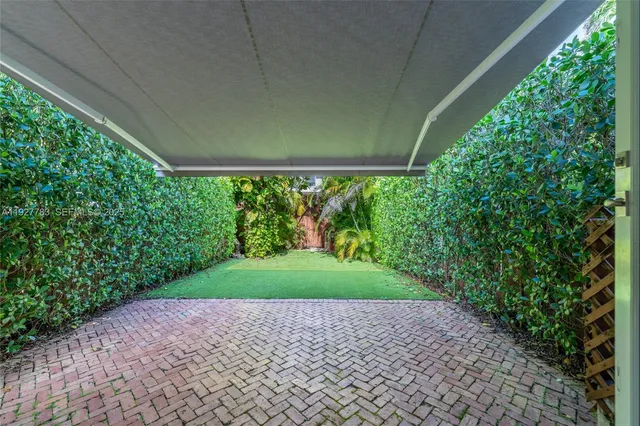 a view of garden with wooden fence