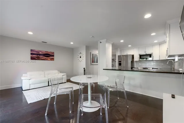 a kitchen with stainless steel appliances kitchen island granite countertop a sink and cabinets